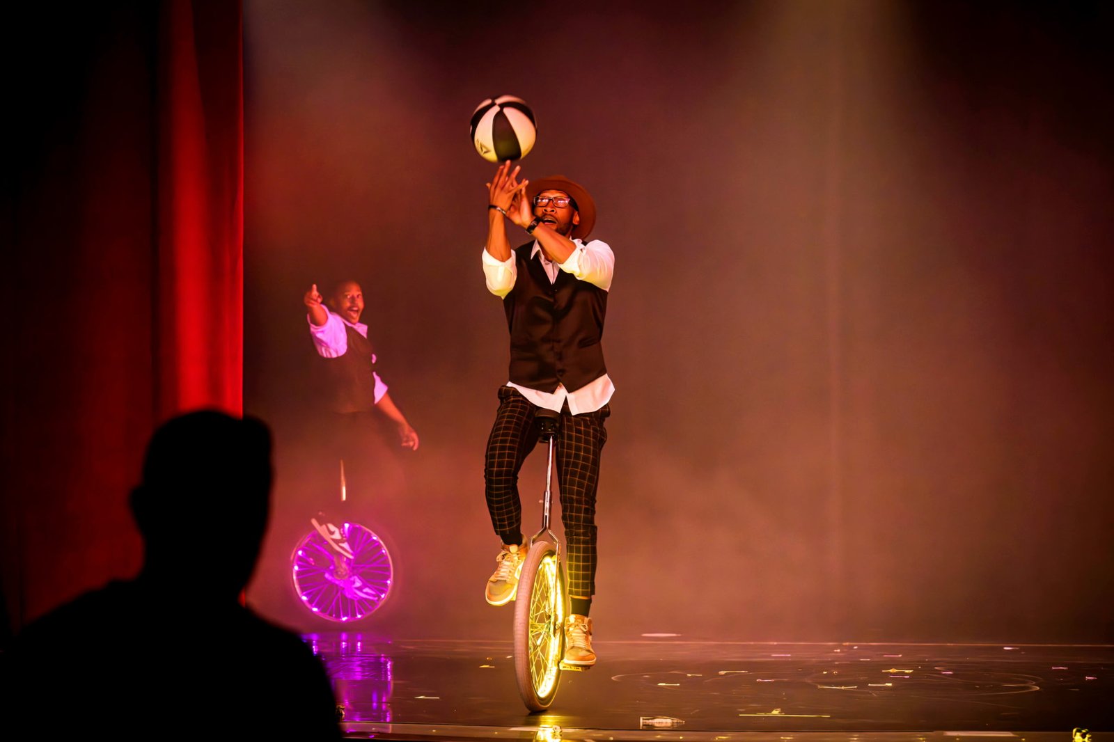 Kaseem Alamudeen performing a basketball balance act on stage