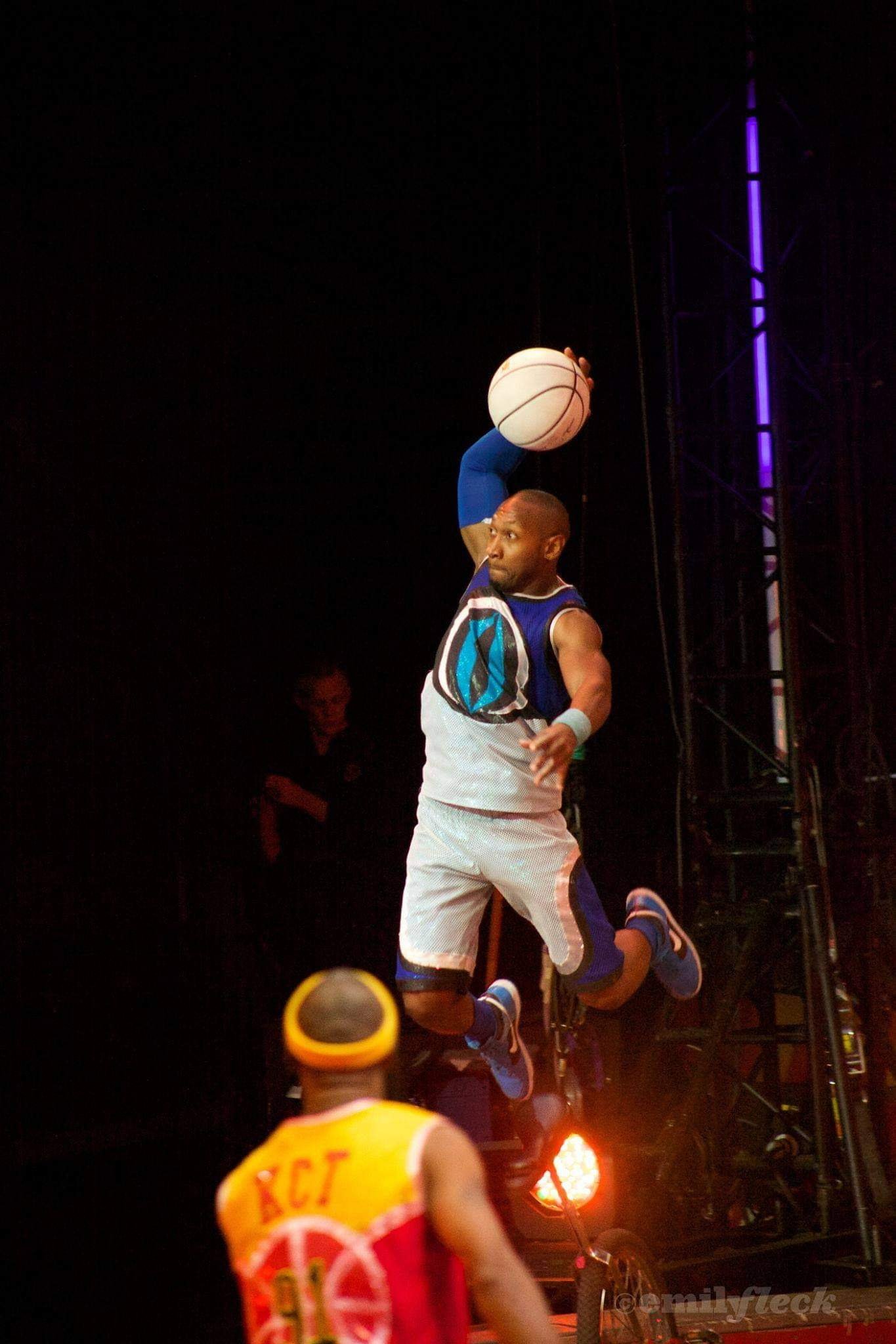 Kaseem Alamudeen performing a basketball trick while riding a unicycle