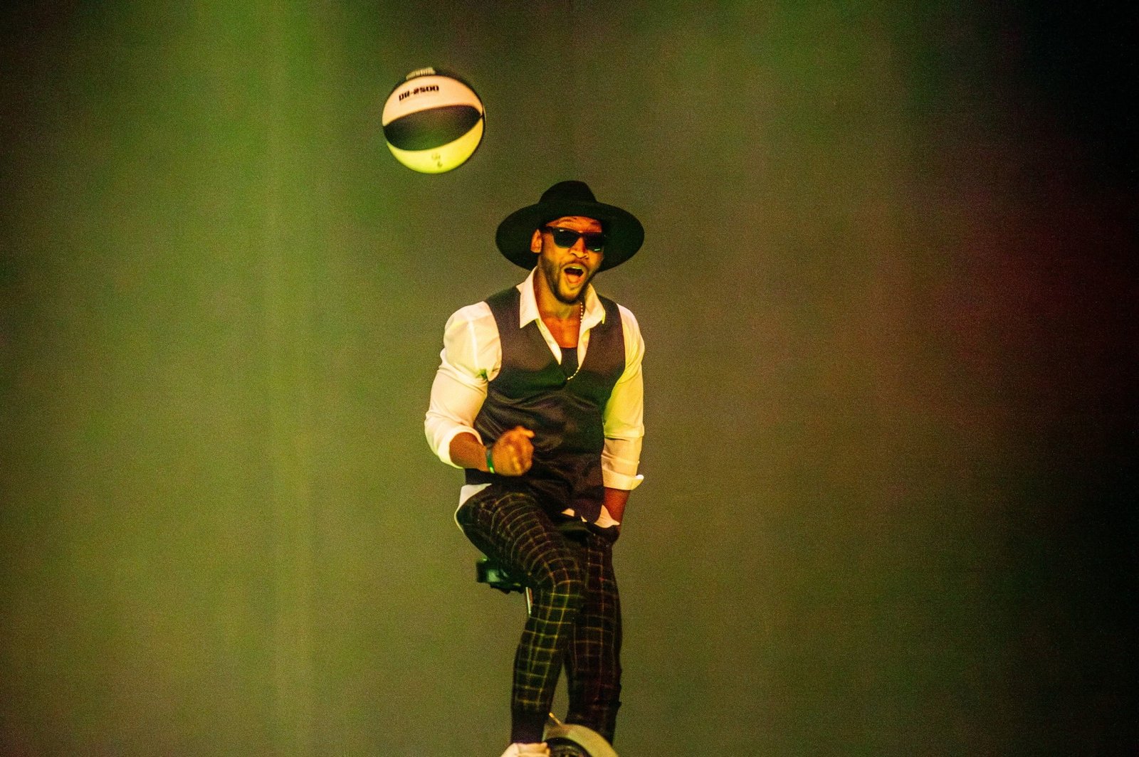 Kaseem Alamudeen spinning a basketball during a live stage performance