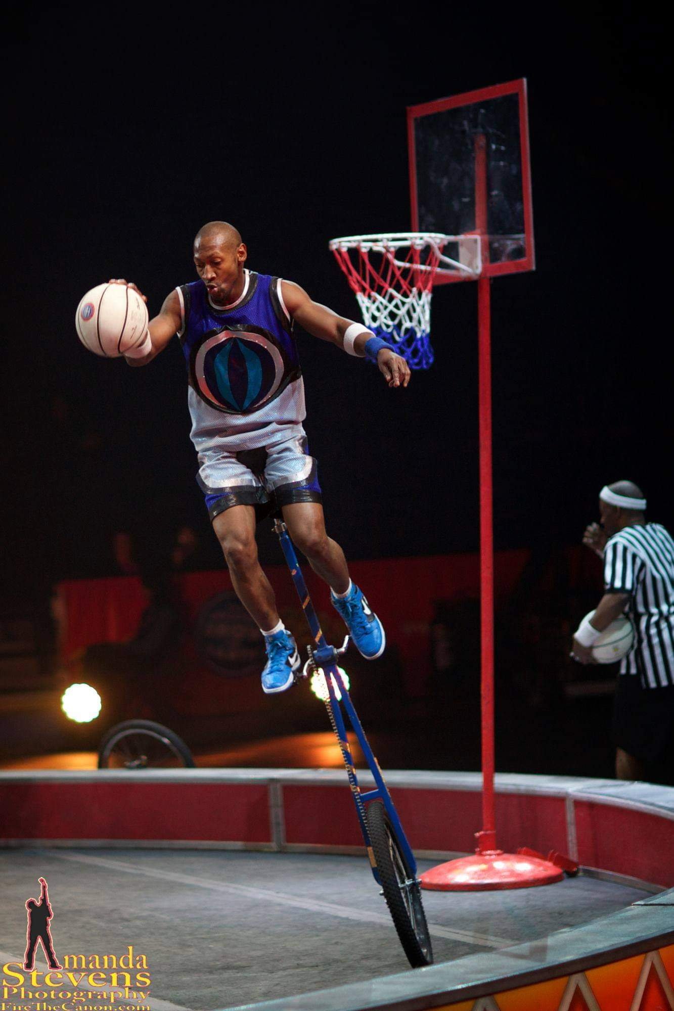 Kaseem Alamudeen performing unicycle basketball near the hoop