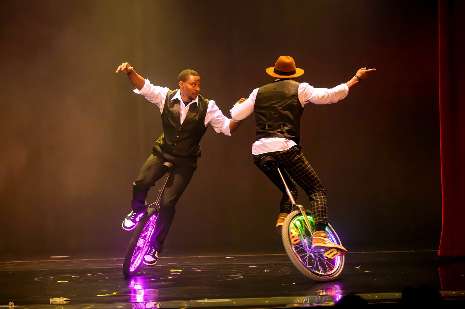 Kaseem Alamudeen performing a unicycle duo routine with LED wheels