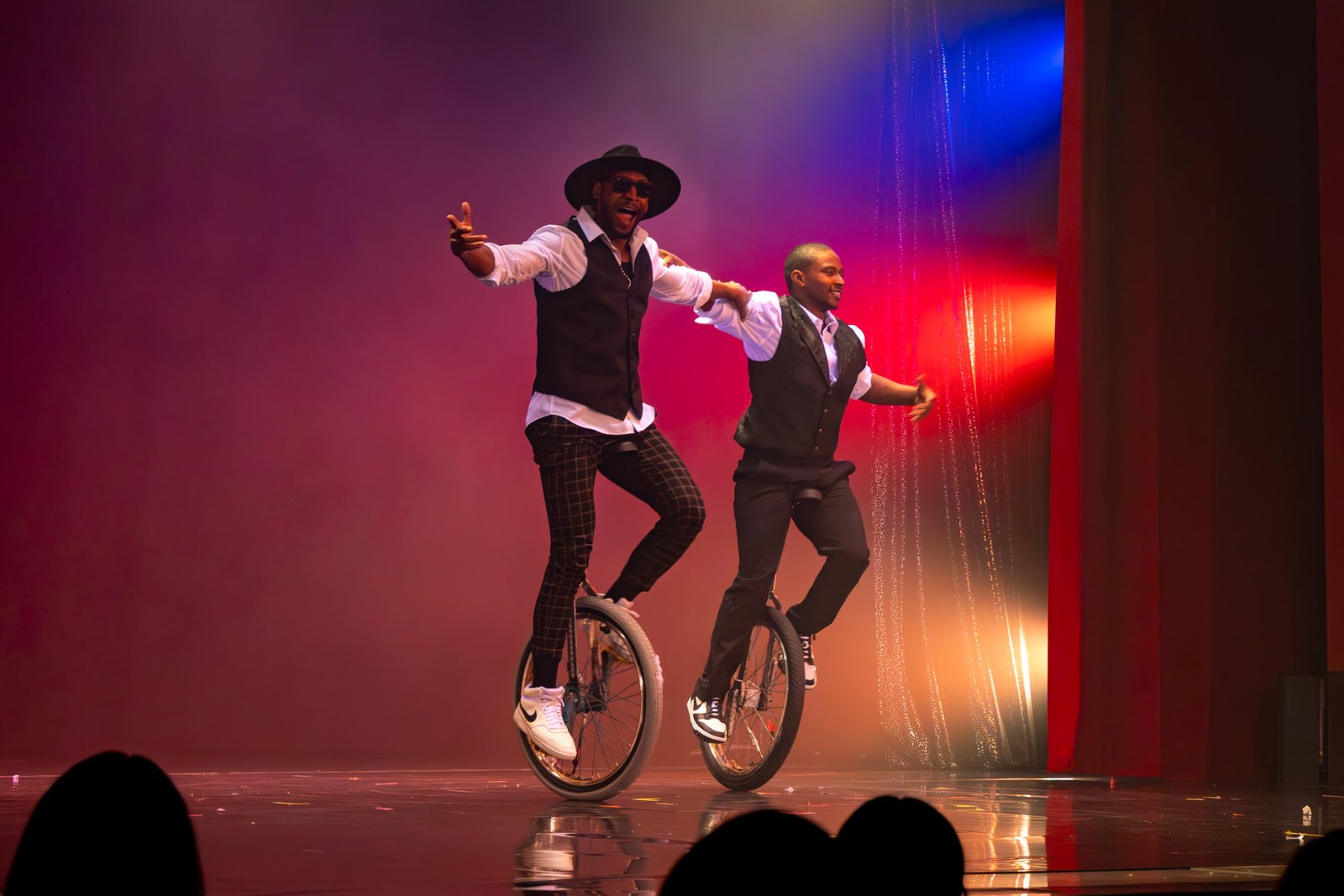 Kaseem Alamudeen and a fellow unicyclist performing a live duo stage act